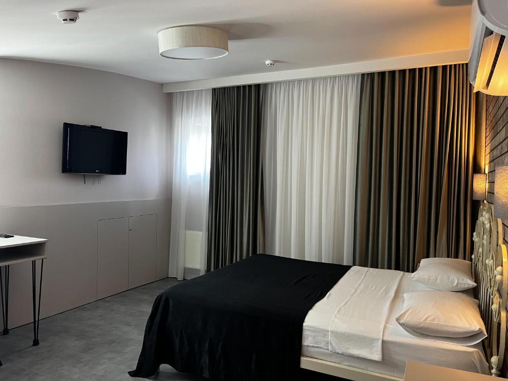 Postel nebo postele na pokoji v ubytování Komilfo Hotel