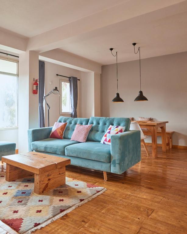a living room with a blue couch and a table at Ananya Apartments Phase 1 in Kathmandu