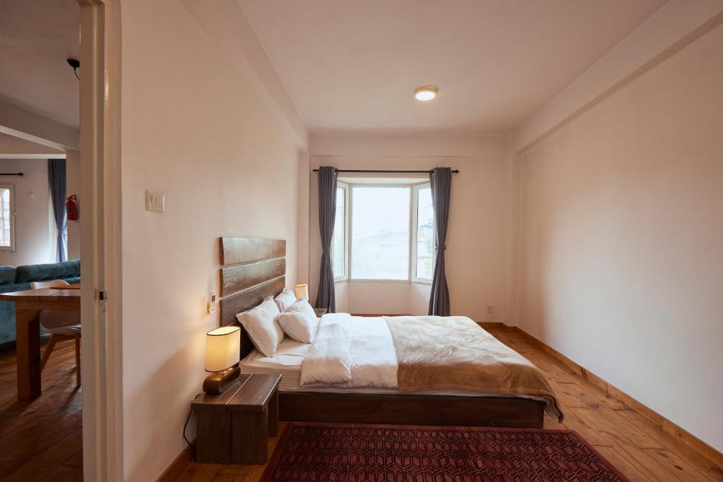 a bedroom with a large bed and a window at Ananya Apartments Phase 1 in Kathmandu