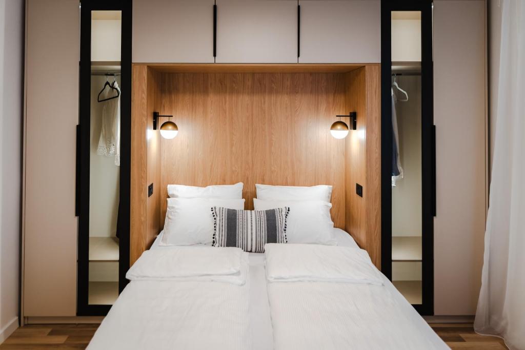 a bedroom with a large bed with white pillows at Atelier 51 - Free parking in Mostar
