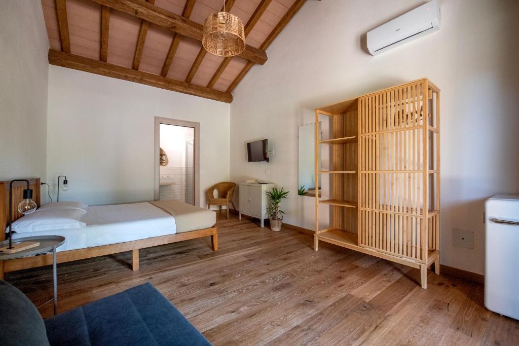 a bedroom with a bed and a book shelf at Agriturismo La Sassicaia in Castiglione della Pescaia