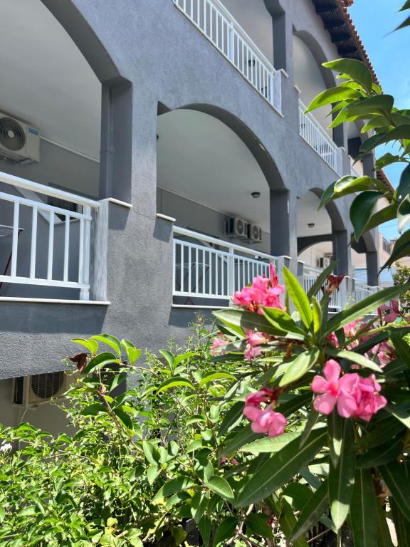 a building with pink flowers in front of it at ELPIDA View in Kallithea Halkidikis