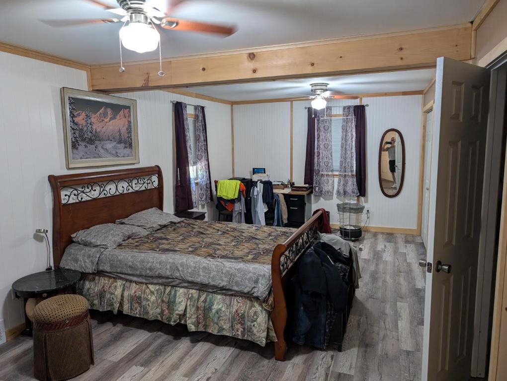 a bedroom with a bed and a ceiling fan at Landry's Laire in Crescent