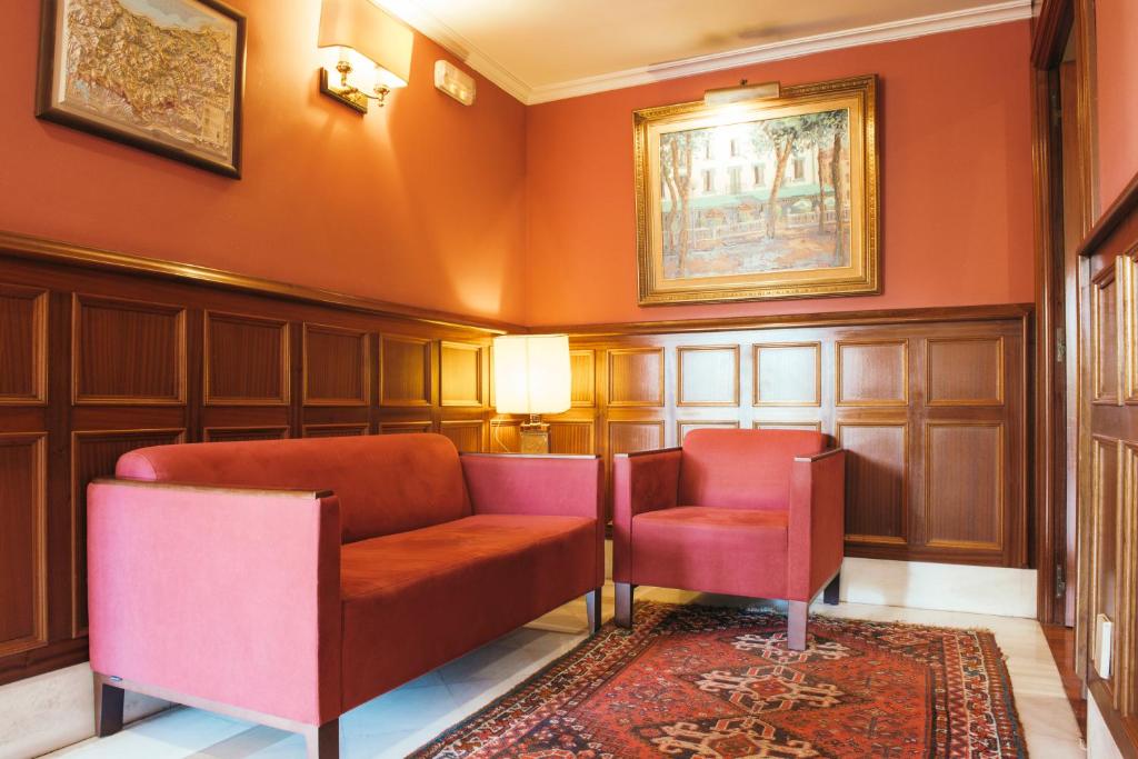 a waiting room with two chairs and a rug at Hotel Alameda in Zarautz