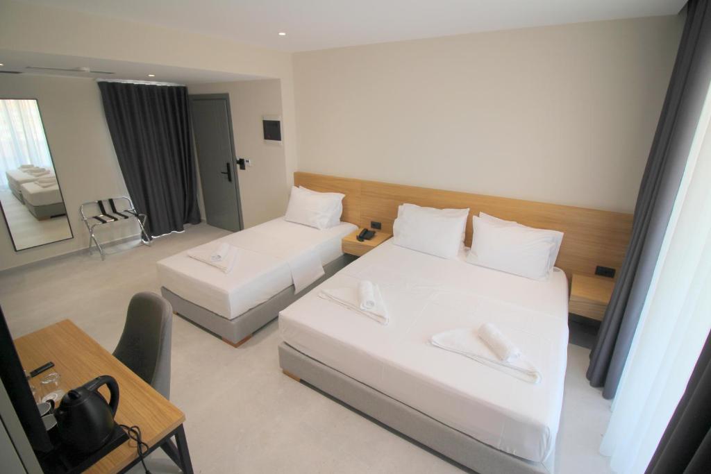 Postel nebo postele na pokoji v ubytování Niklas Boutique Hotel
