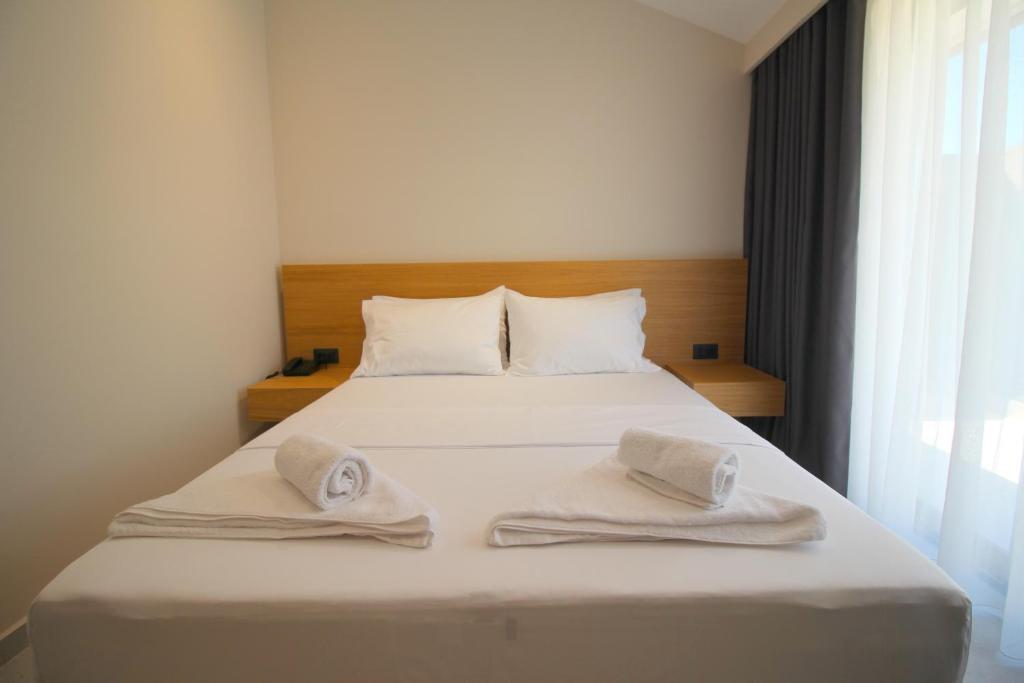 Postel nebo postele na pokoji v ubytování Niklas Boutique Hotel
