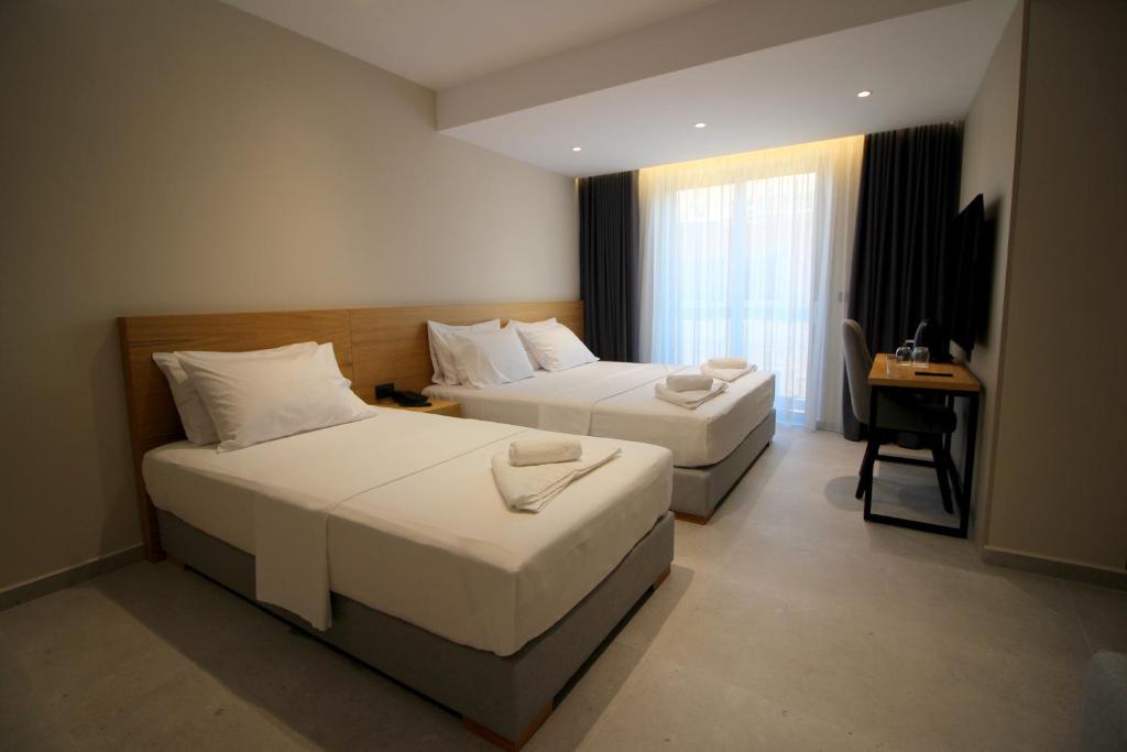 Postel nebo postele na pokoji v ubytování Niklas Boutique Hotel