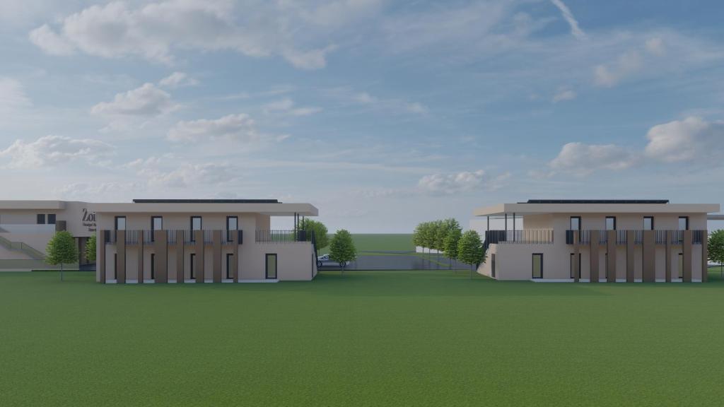 a rendering of two buildings in a green field at Monteurzimmer - SIDO Immobilien in Neupirka