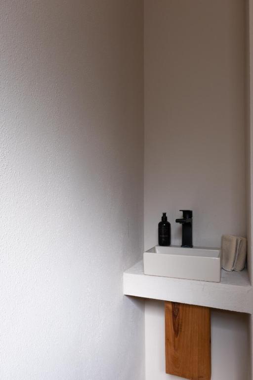 a room with a shelf with two bottles on it at GAIA Alaçatı BY THE SEA - Adult Only in Çeşme