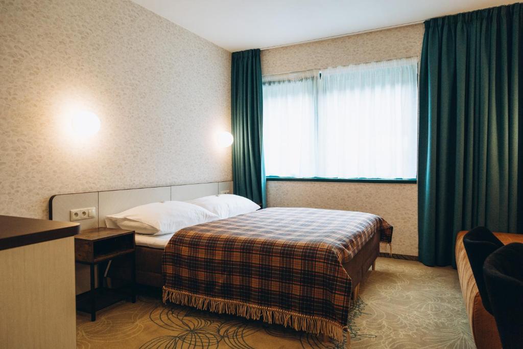 Postel nebo postele na pokoji v ubytování Hotel Vodník
