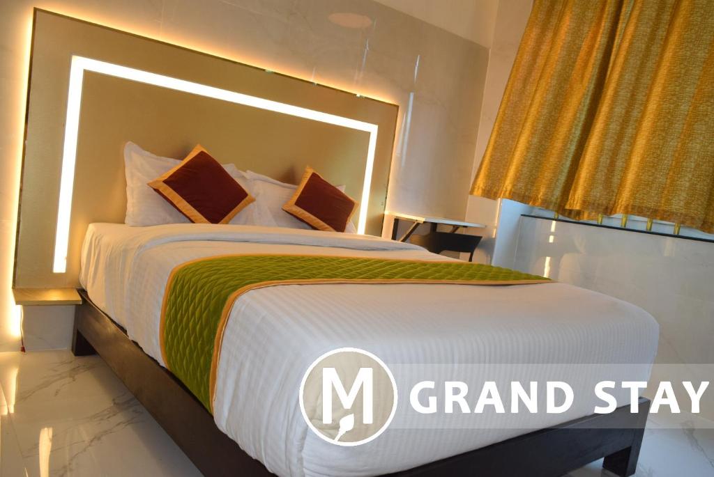 Postel nebo postele na pokoji v ubytování M Grand Stay