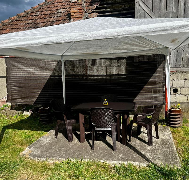 Una carpa con sillas y una mesa debajo. en Casa Dia, en Turda