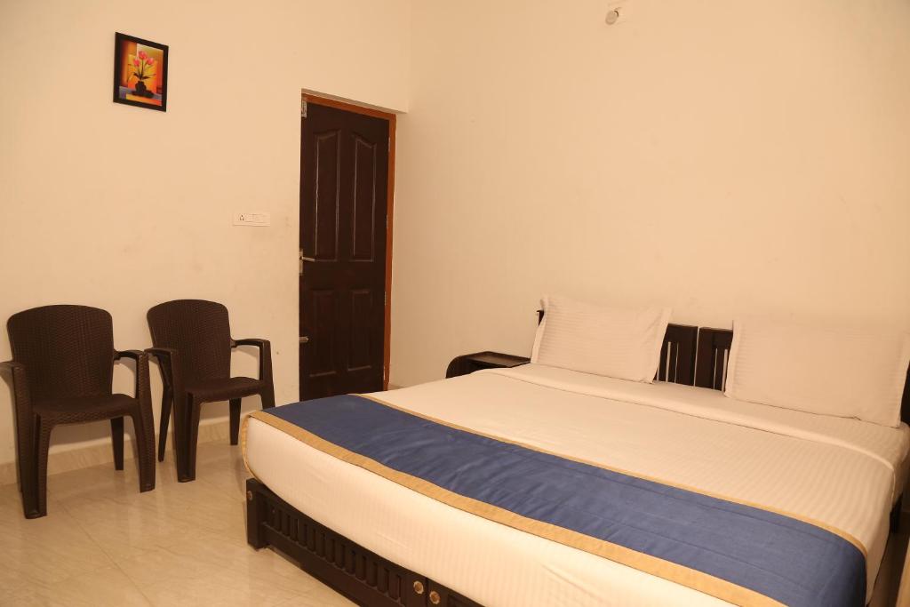 Postel nebo postele na pokoji v ubytování Nandana's Residency Munnar
