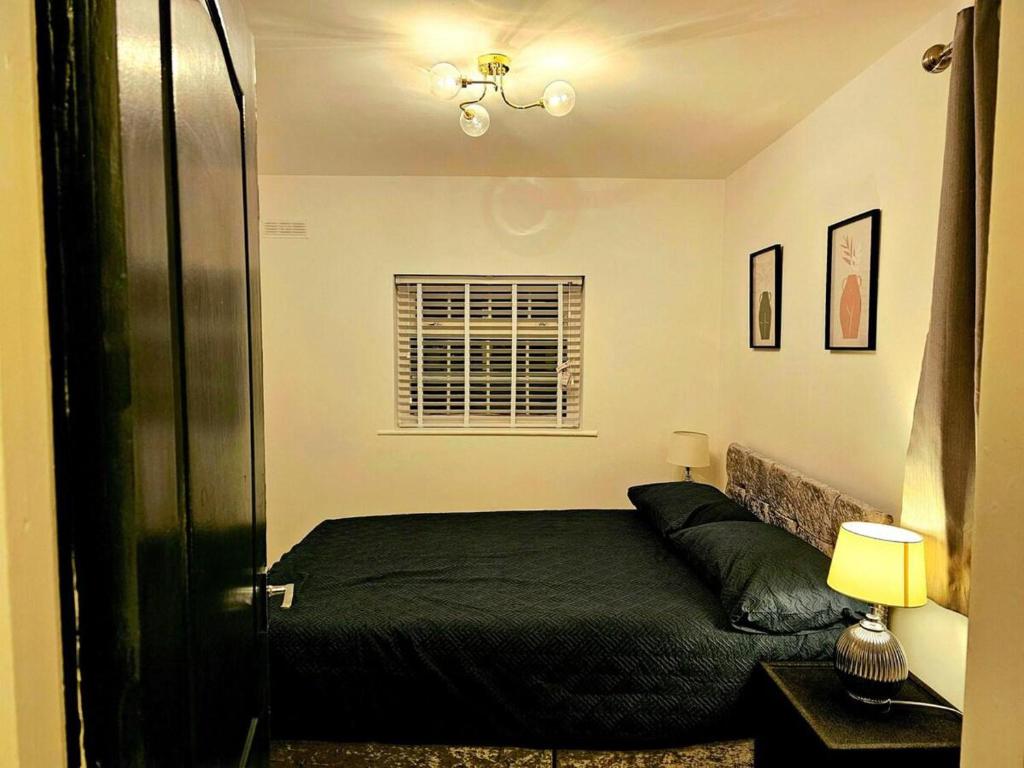 a bedroom with a bed and a window at Flat - Sleeps 4 - WiFi in Bridgend