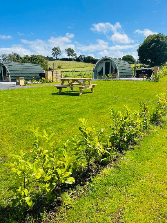 a picnic table in a field with green grass at Knockmany View Glamping in Augher