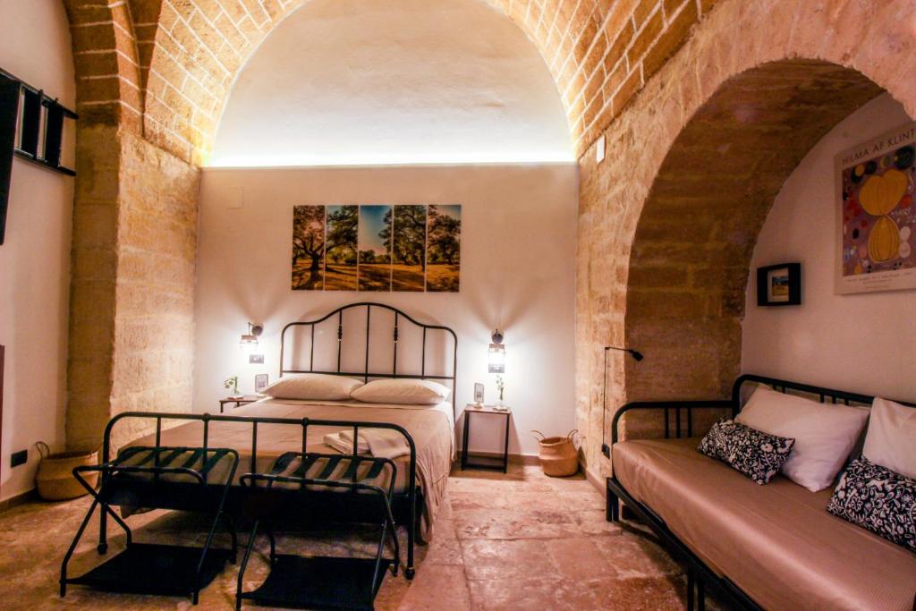 a bedroom with a bed and a couch at Loft57 L&G - Centro storico in Bari