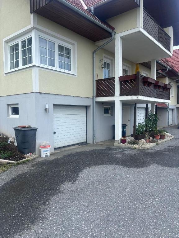 a house with a garage and a driveway at Romy in Deutschlandsberg