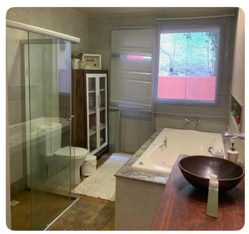 a bathroom with a bath tub and a sink at Arandela OuroPreto in Ouro Preto