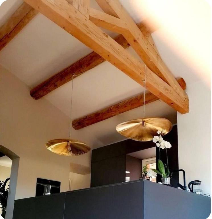 two lights hanging from the ceiling in a room at Là où le Ciel est né Beau mas pierres et contemporain sur grande propriété vue Mont Ventoux dentelles de Montmirail in Blauvac