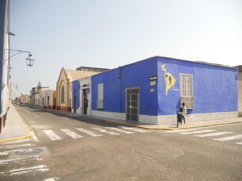 a blue building on the side of a street at El Mochilero in Trujillo
