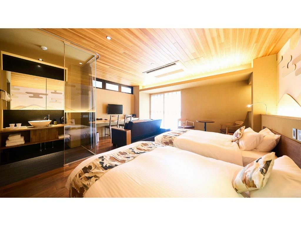 a hotel room with two beds and a bathroom at Kikoku no mori - Vacation STAY 31759v in Kyoto