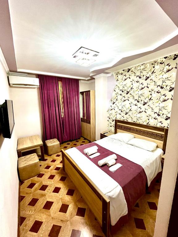 a hotel room with a bed with towels on it at Georgian Palace Hotel in Kutaisi
