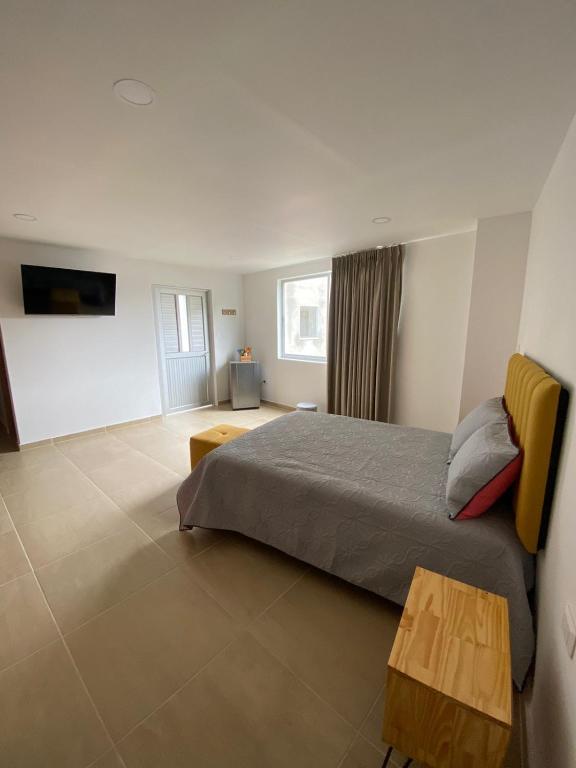 Postel nebo postele na pokoji v ubytování BISÁU Hotel