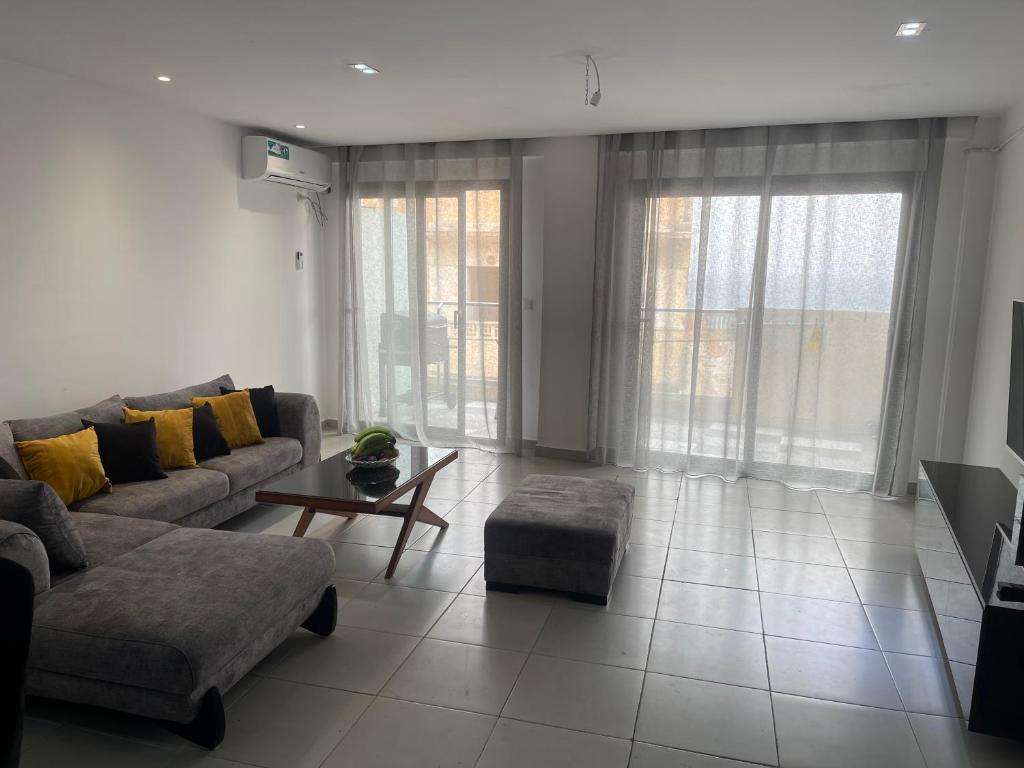 a living room with a couch and a table at Rue de Paris - Plage Saint Germain - vue sur mer - in 'Aïn el Turk