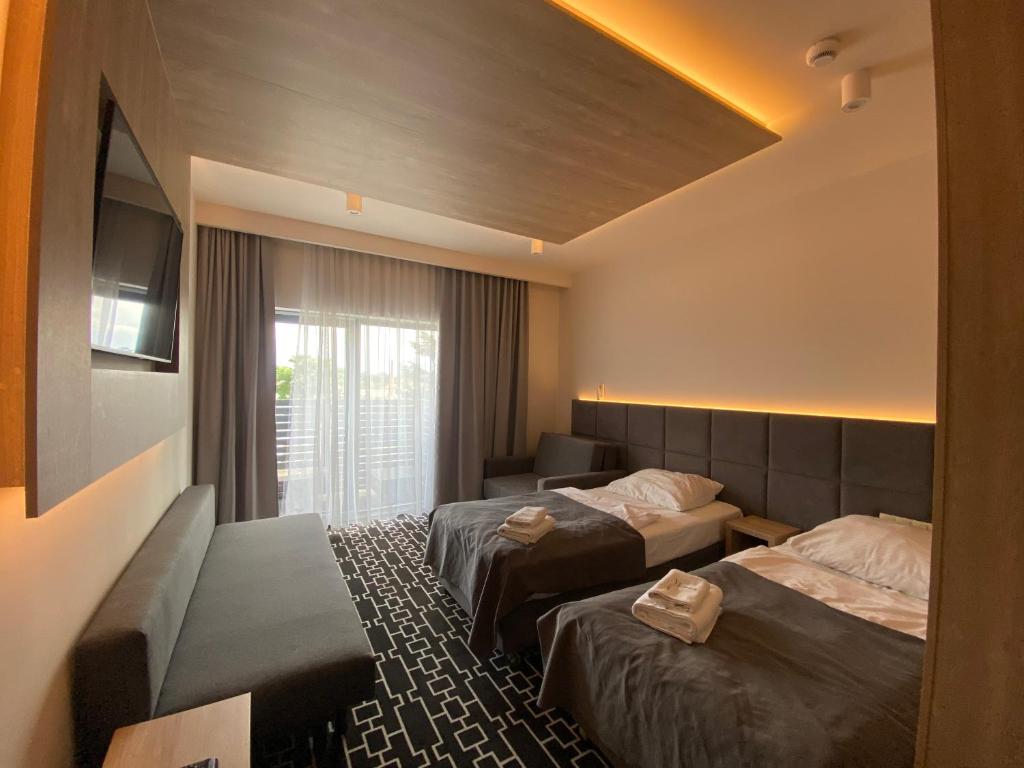 Postel nebo postele na pokoji v ubytování Hotel Wena