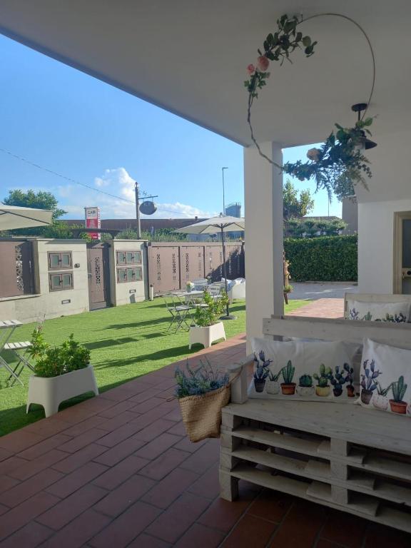 a patio with potted plants and a view of a yard at casa vacanza GIOIA in Civitanova Marche