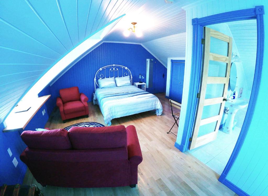 a bedroom with a bed and a ladder in a room at Chez Caro et Sylvain in Rimouski