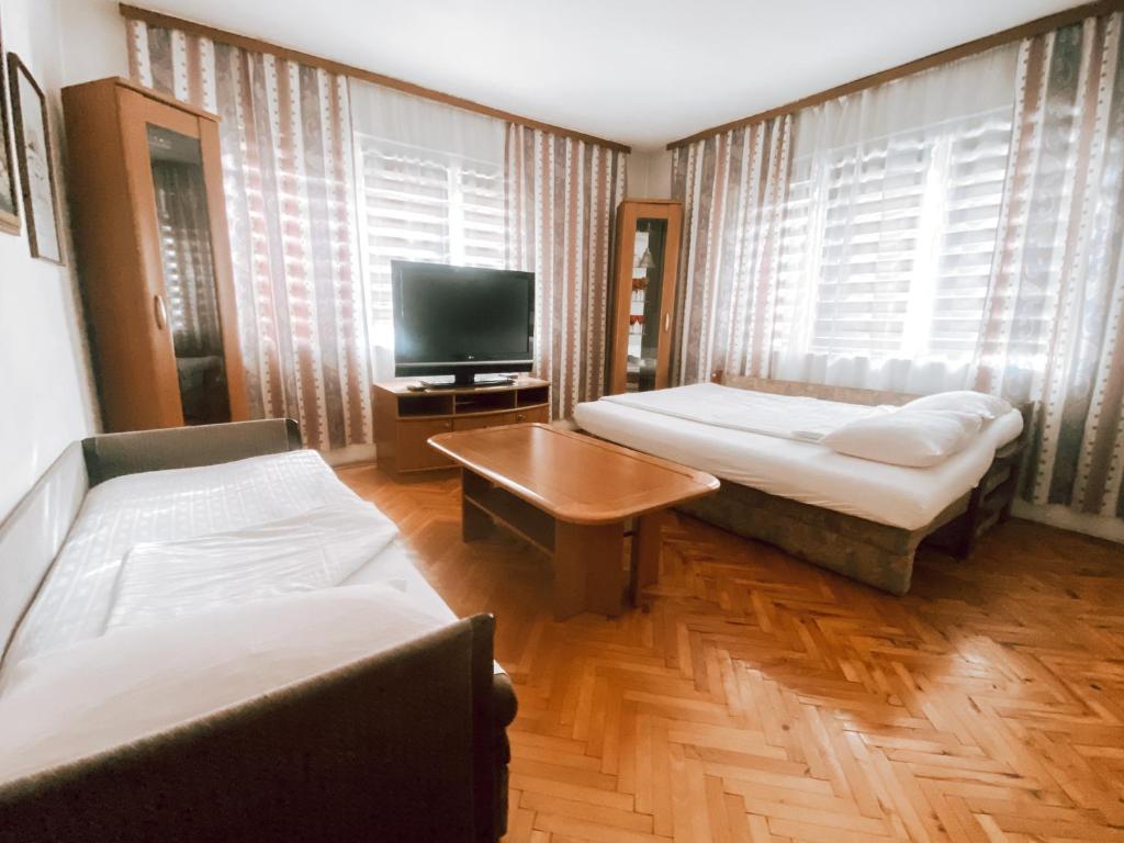 a living room with two beds and a tv at Apartman Carsija in Sarajevo