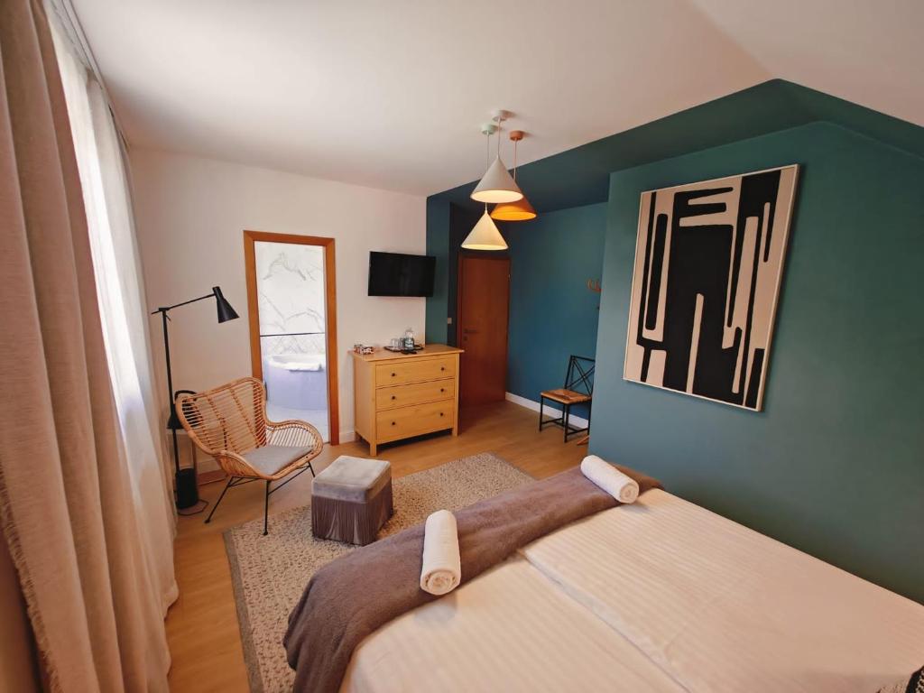 a bedroom with a bed and a chair at Achilla Bed & Breakfast in Český Krumlov