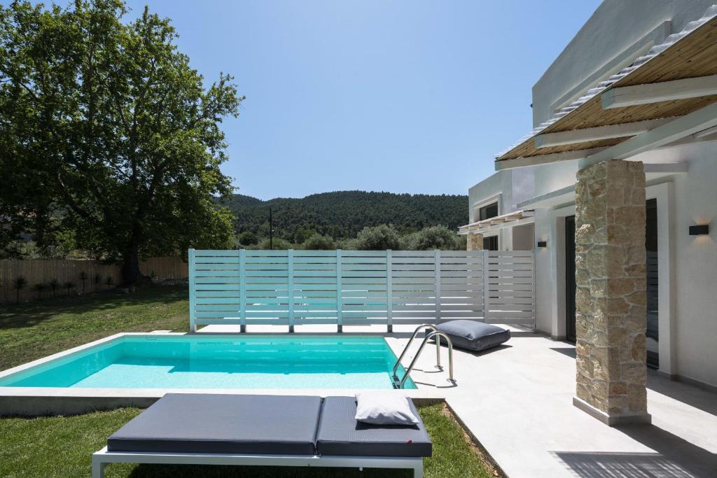 a swimming pool in the backyard of a house at Astrum Luxury Suites in Vourvourou