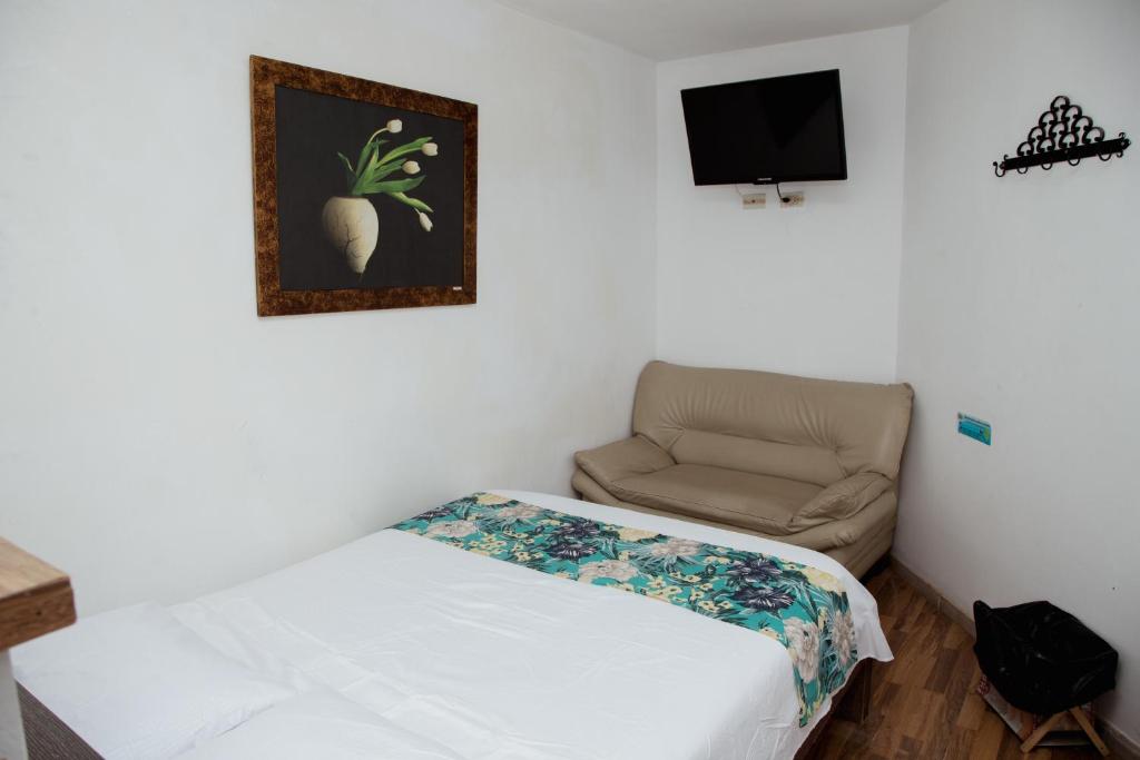 Postel nebo postele na pokoji v ubytování Hotel Portal Guatapé