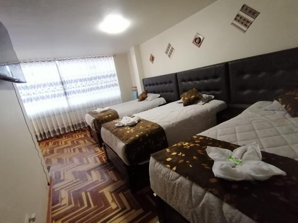 Postel nebo postele na pokoji v ubytování Hostal San Antonio Inn