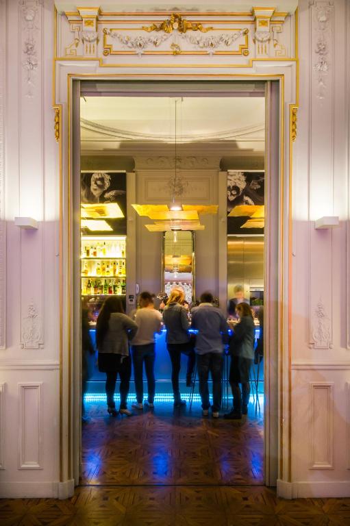 a group of people standing in front of a mirror at Hotel C2 in Marseille
