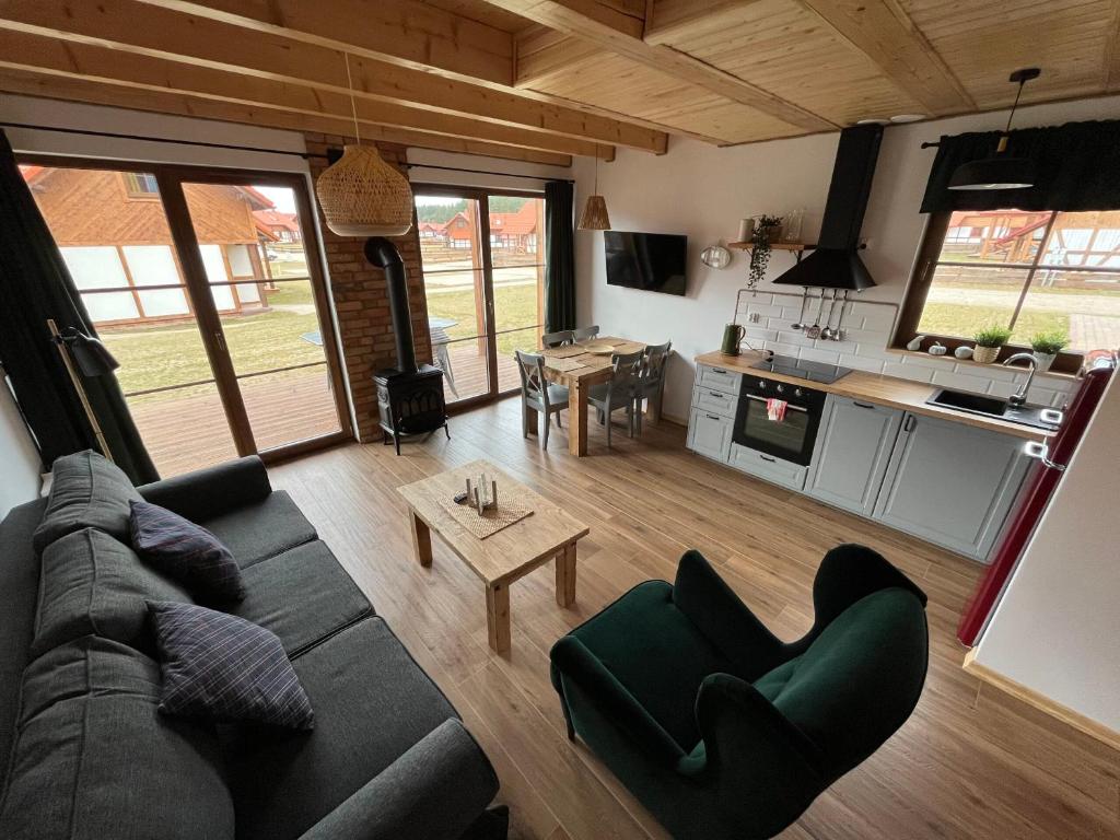 a living room with a couch and a table at Domek na Kaszubach 45-2 - Ostoja Bukowo in Borowy Młyn
