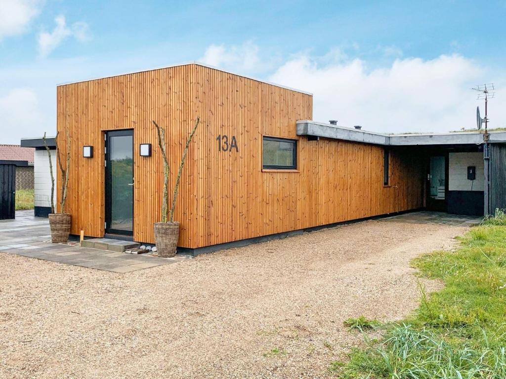 a wooden building with the word beta written on it at Beachfront Bliss in Vesterhavet - By Traum Ferienwohnungen in Vrist