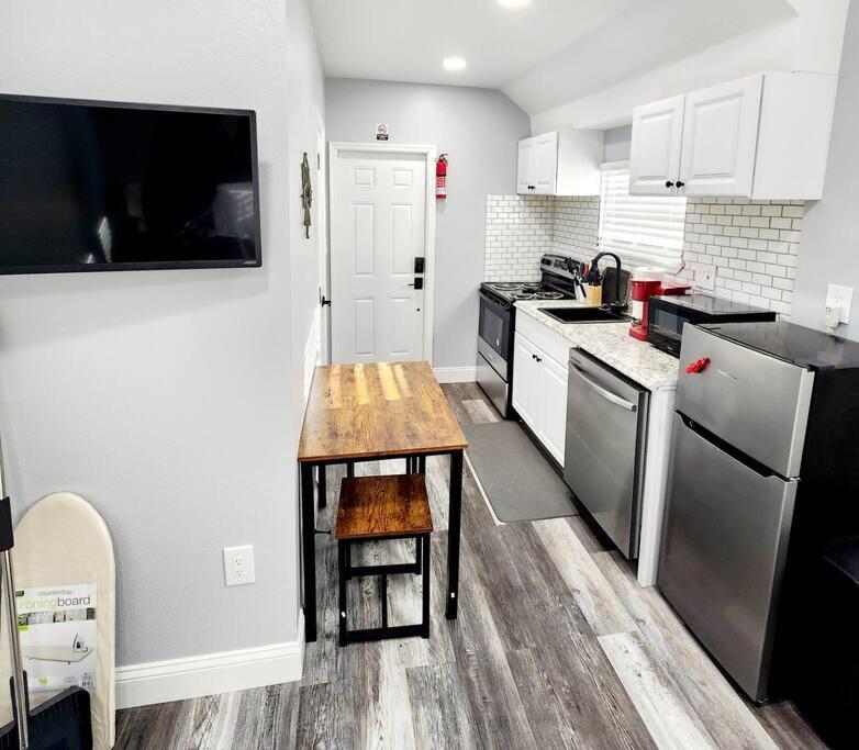 a small kitchen with a wooden table in it at Green Roof House Studio in Lakeland