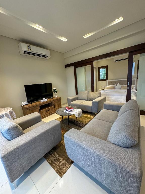 a living room with couches and a flat screen tv at هوانا ڤيو - Hawana view in Ma‘mūrah