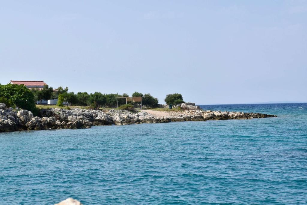 an island in the middle of a body of water at Seaside holiday house Cove Krlic, Pag - 23435 in Novalja