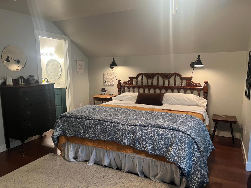 a bedroom with a large bed and a black dresser at Snowgoose Pond Bed & Breakfast in Palmer