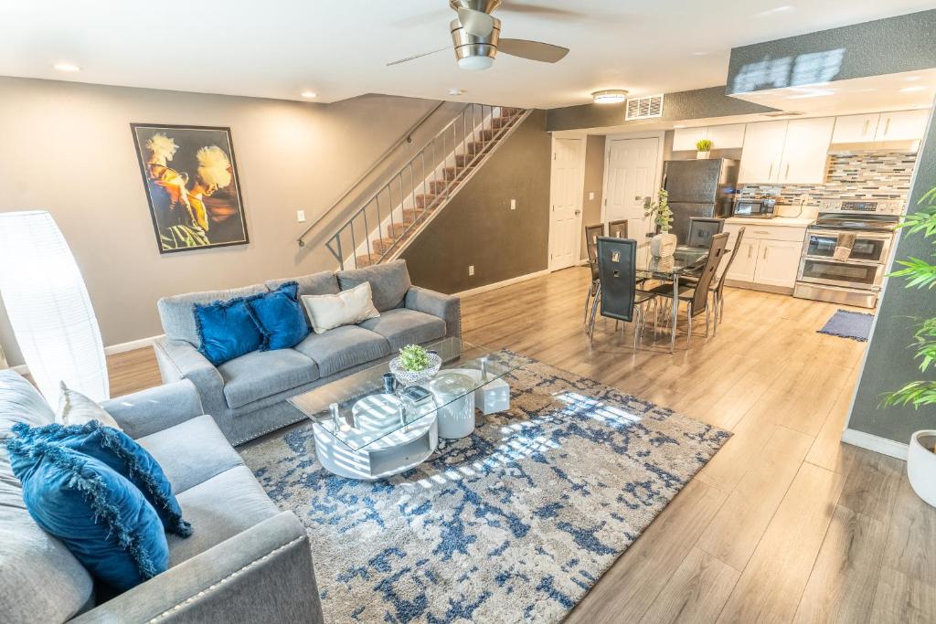 a living room with a couch and a table at Spacious 2-Bedroom Townhouse with Pool & Private Patio in Central Las Vegas in Las Vegas