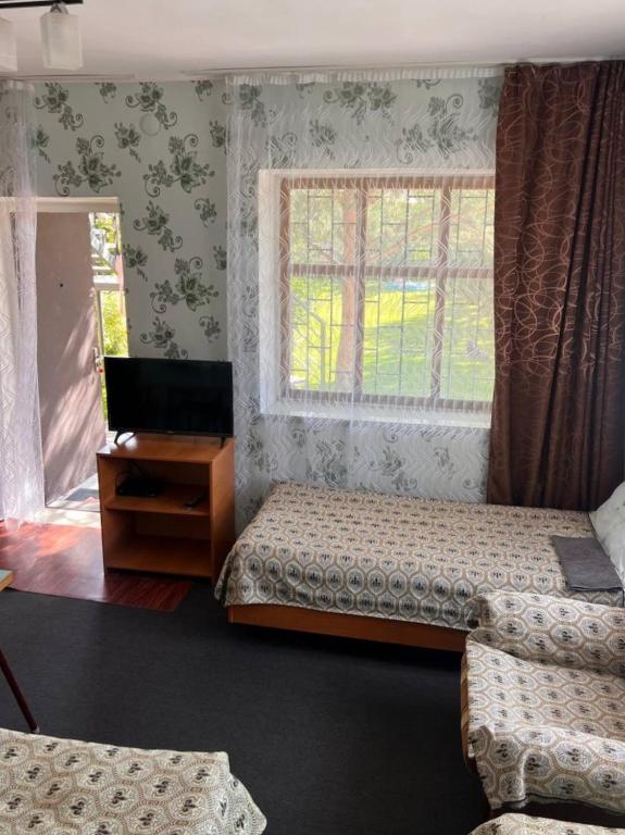 Postel nebo postele na pokoji v ubytování Podsolnukhi Guest House