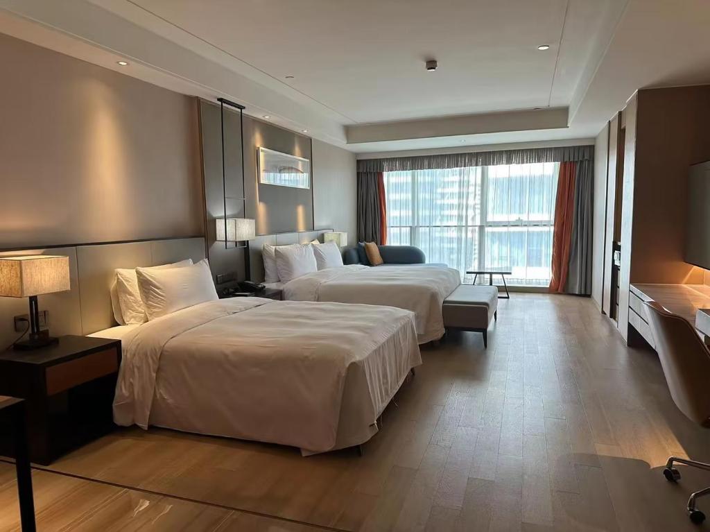 Postel nebo postele na pokoji v ubytování HongQiao Primus Residence Apartment - National Exhibition Center