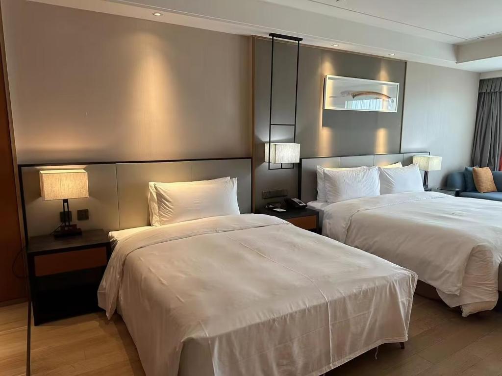 Postel nebo postele na pokoji v ubytování HongQiao Primus Residence Apartment - National Exhibition Center
