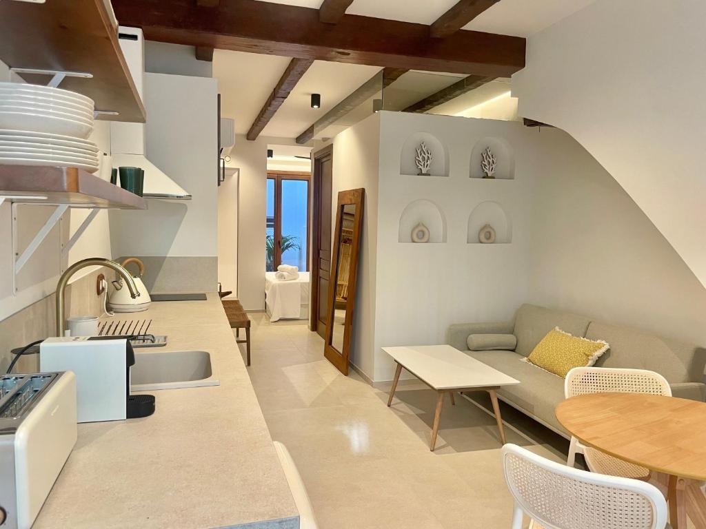 a kitchen and living room with a couch and a table at Pepitas House in Valencia