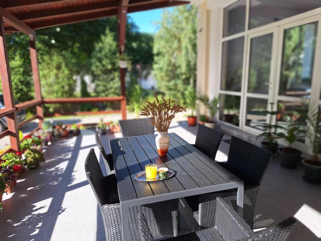 a table with a plate of food on a patio at Casa Astoria in Băile Herculane