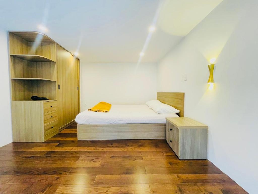 a small bedroom with a bed and a cabinet at KSI-HOME Đà Lạt in Khu Chi Lăng